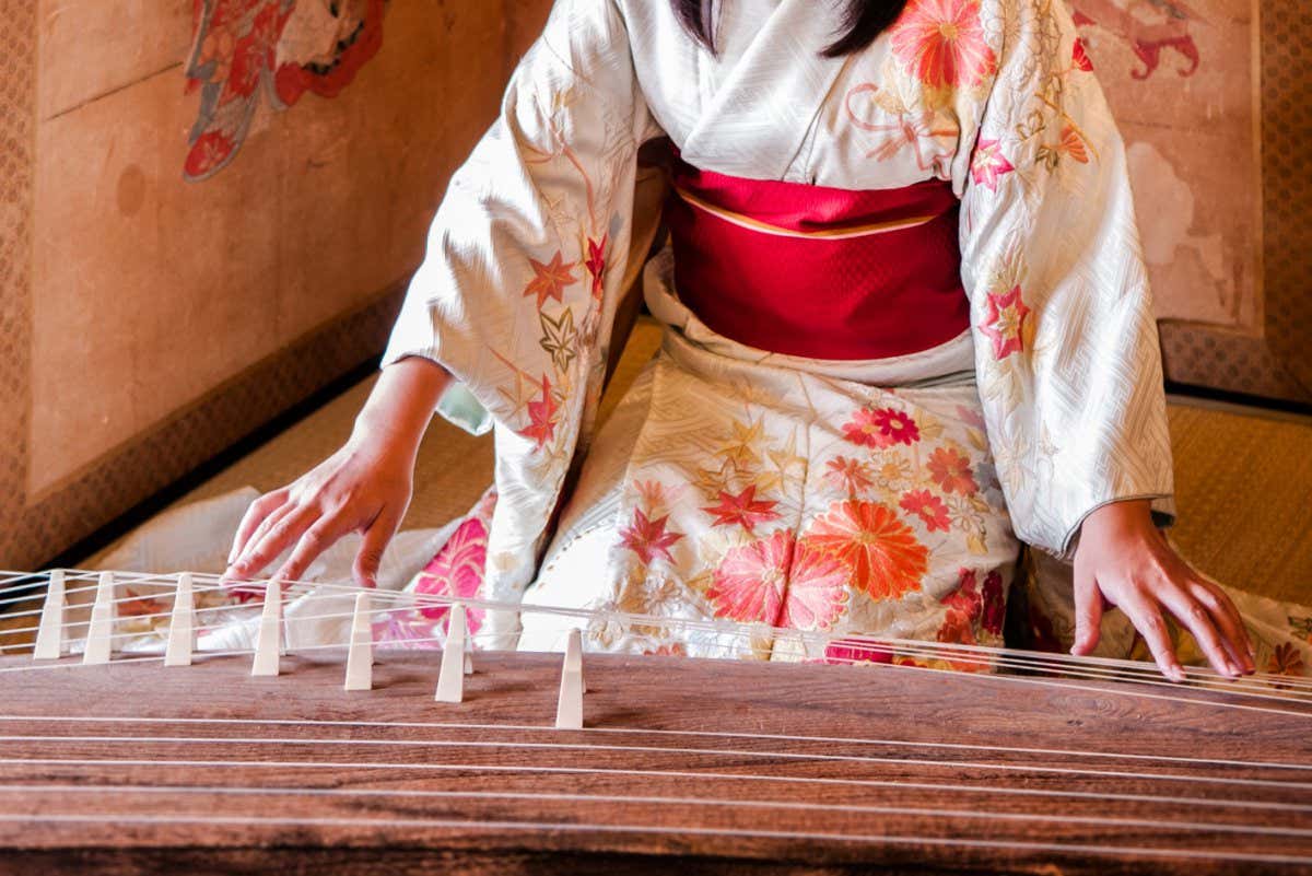 Woman in Kimono dress playing Koto