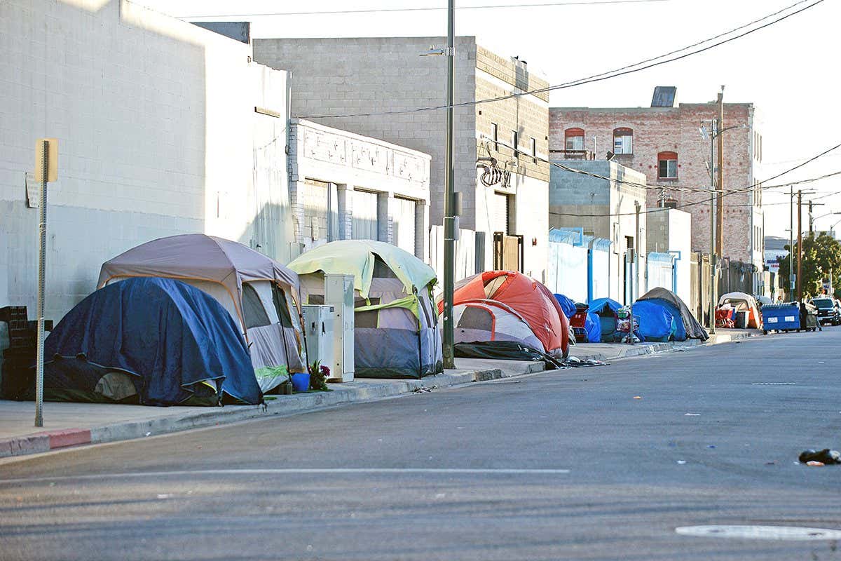 Tents set up along a street in an urban area