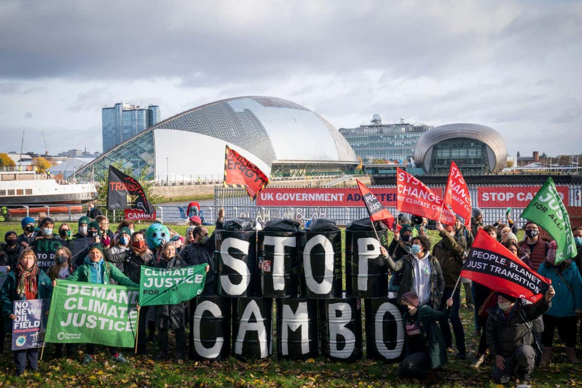 2H56E72 Activists from Friends of the Earth during a demonstration calling for an end to all new oil and gas projects in the North Sea, starting with the proposed Cambo oil field, outside the UK Government's Cop26 hub during the Cop26 summit in Glasgow. Picture date: Sunday November 7, 2021.